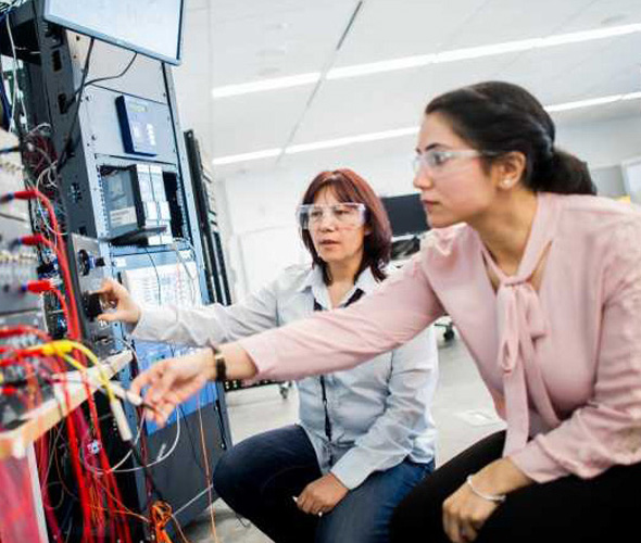 Faculty working with a student in a lab