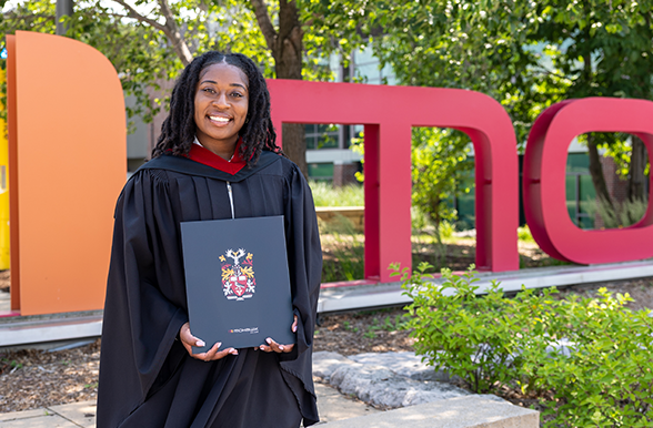 Mohawk Student graduate holding their certification.