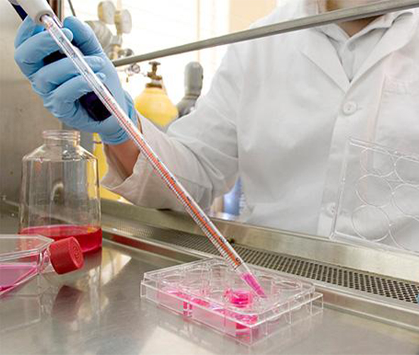 person in lab dispensing chemicals from piette
