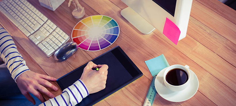 Graphic Designer drawing on a tablet on her desk