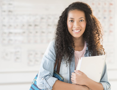 student carrying their notebooks