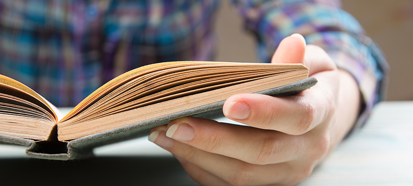 Student reading from a book