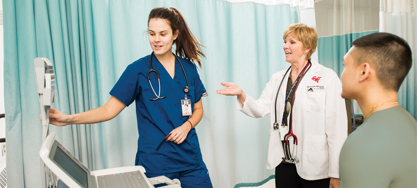 mohawk student working under guidance of faculty at the mohawk centre for health care simulation at the institute for applied health sciences at mcmaster