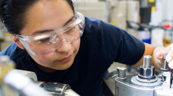 Woman working on machinery