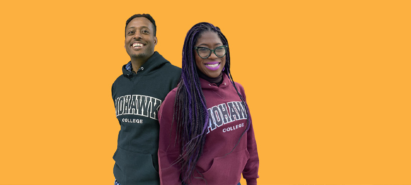 two mohawk students wearing mohawk hoodies