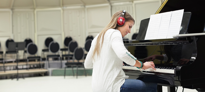 a student writing down music on notebook