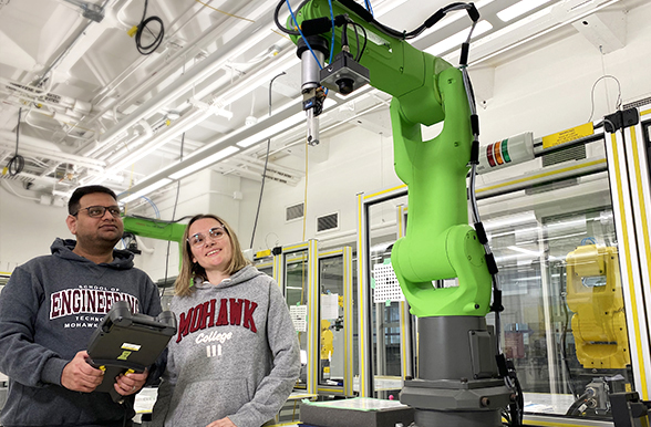 Mohawk College students operating the fanuc robot arm