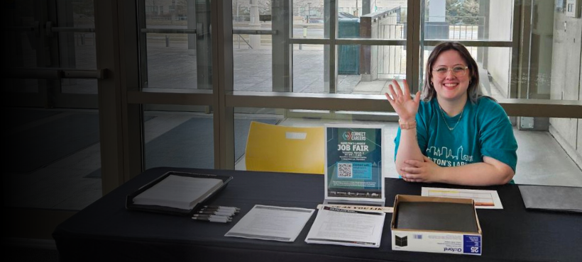 Student sitting at a welcome table.