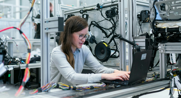 female working on technology machines