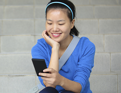 student playing with mobile phone