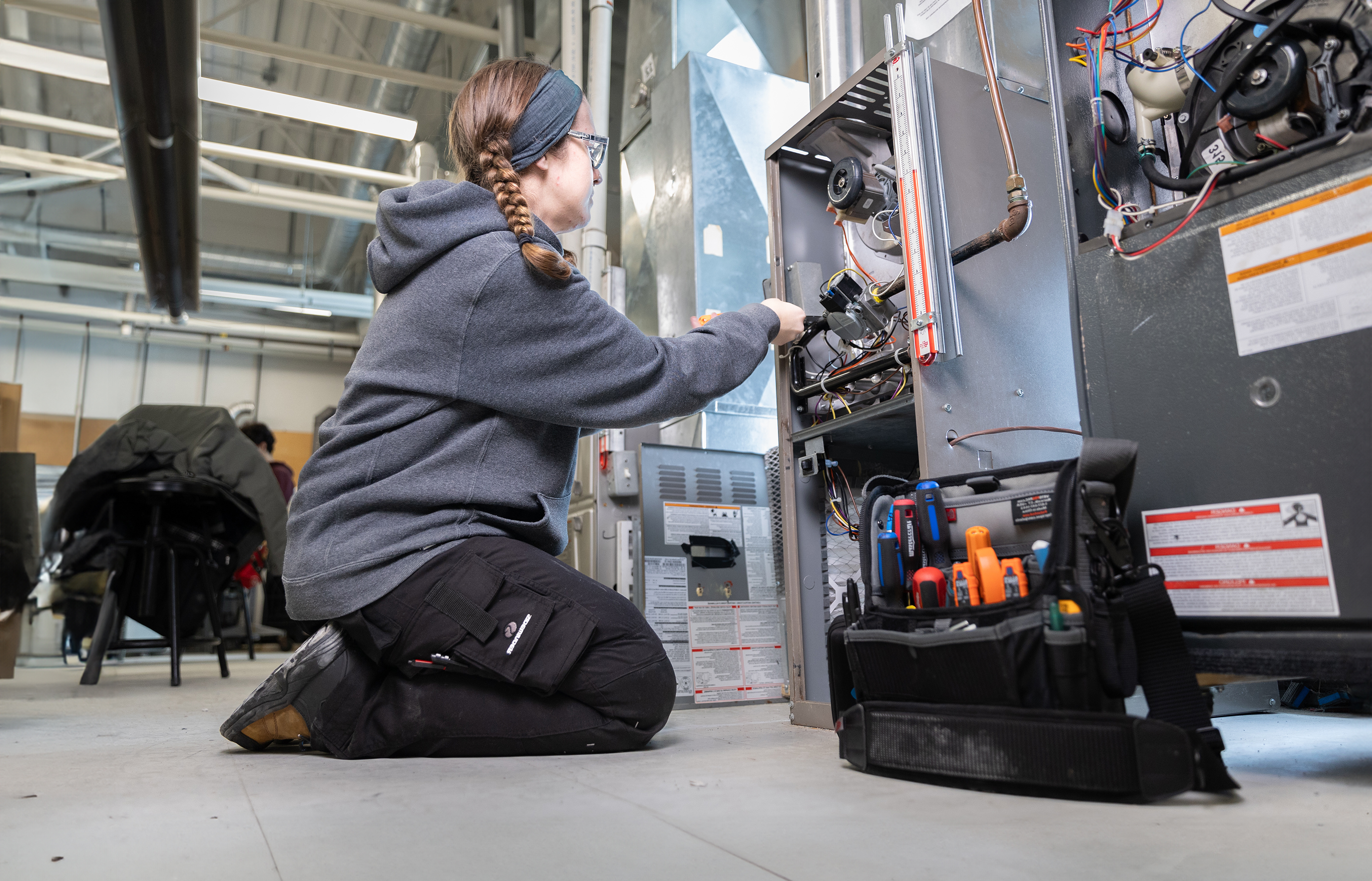 Amanda, a student in the Gas and Oil Burner Technician (049) program, working in a lab.