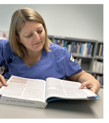 Nursing student reading a textbook