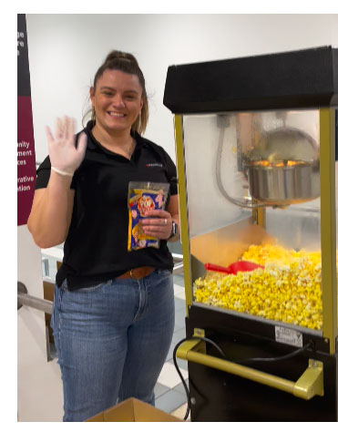 Helper giving out popcorn on campus