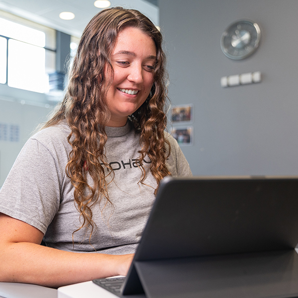 Maggie working on a laptop.