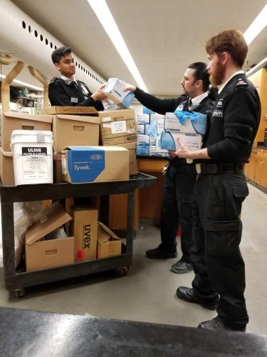 Mohawk Security team sorting through medical equipment to donate