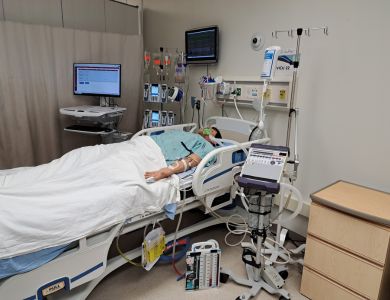 Simulator 'Apollo' seen laying in hospital bed with various pieces of equipment to create a simulated high acuity environment as part of one of the newly created Sonography Simulations