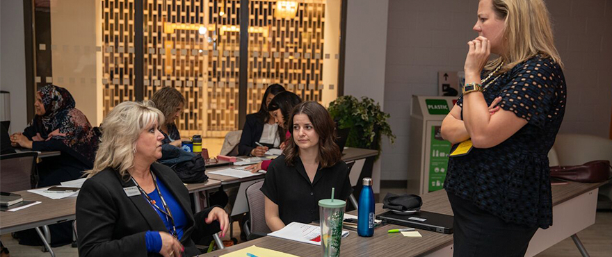 Three people discussing at an event