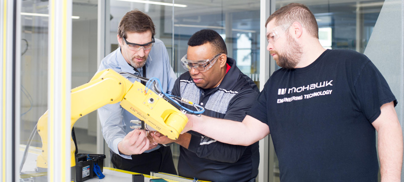 Students and staff working with FANUC technology