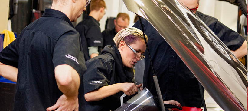 mohawk students in the Garage fixing a car