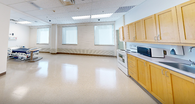 Lab showing a bed and kitchen area at Mohawk College IAHS Campus