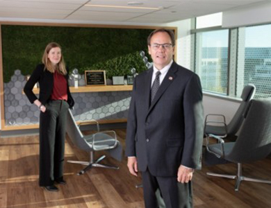 Man and woman standing in office