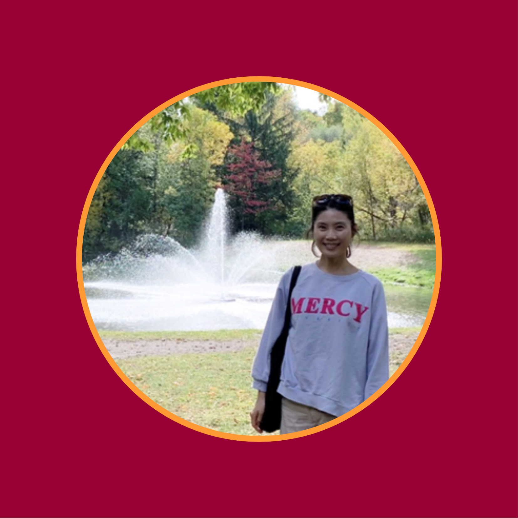 Jisoo standing with a fountain and trees in the background