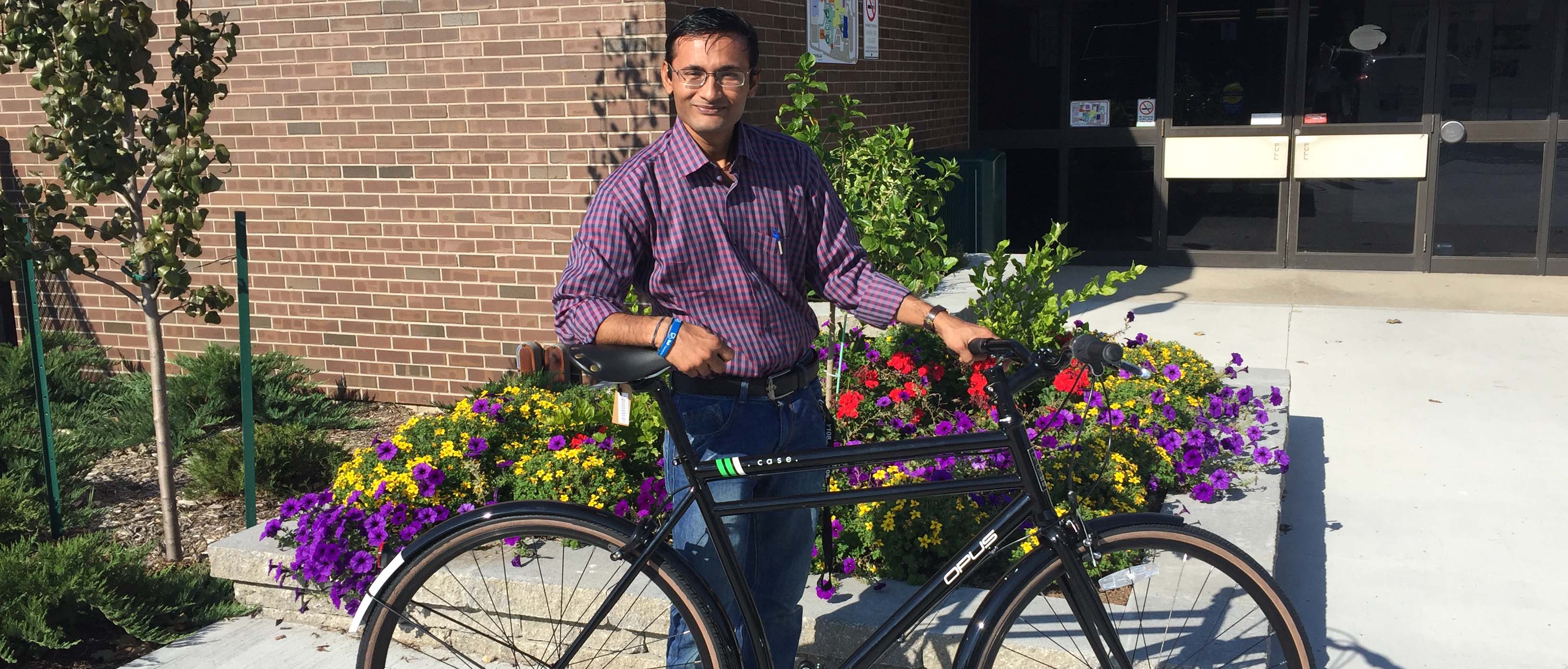 Student standing with bicycle