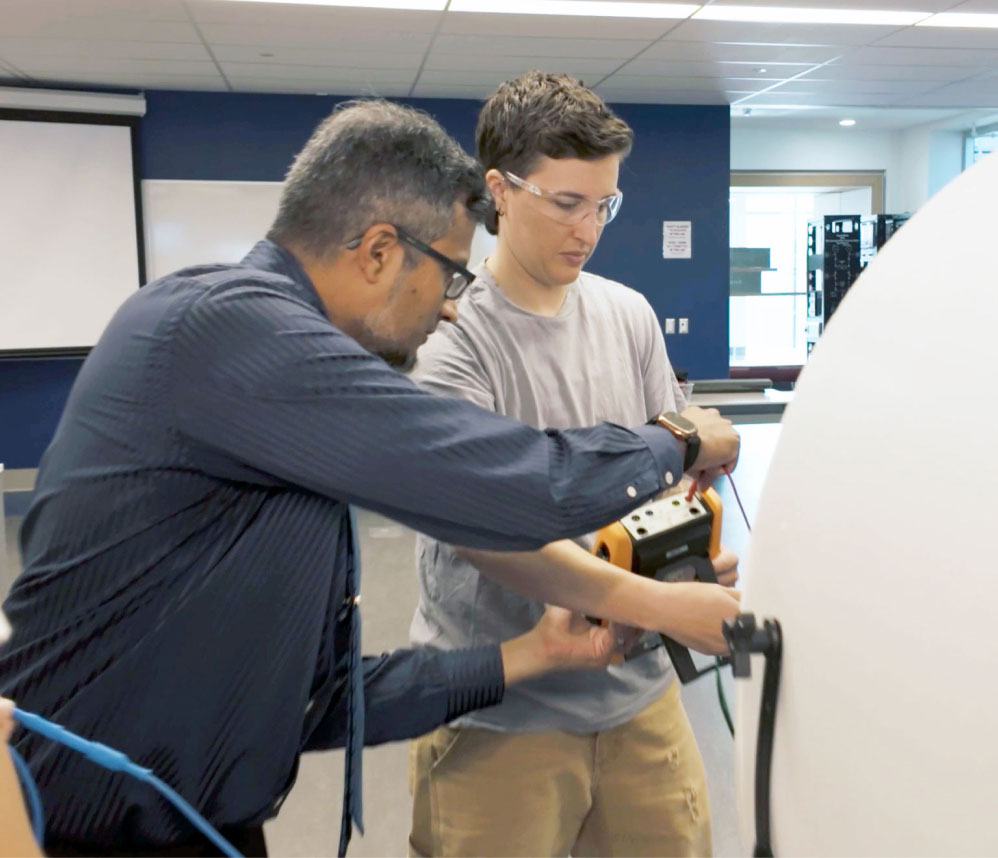 A Mohawk college faculty member and a student collaborating together on a project