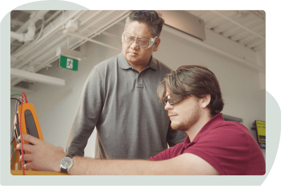Student working on a project under the watch of Mohawk Faculty