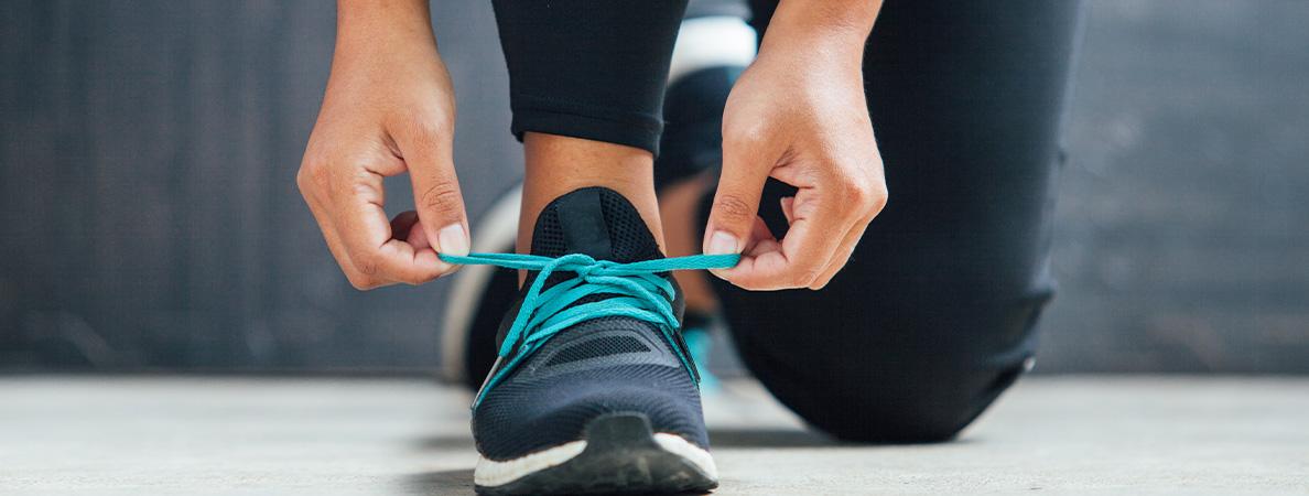 student athlete tied her shoe ready to run 