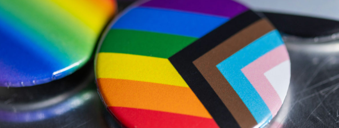 An image of a table with a progress pride flag button on it