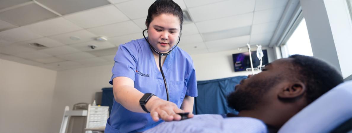 Uyen examines a patient with a stethoscope.