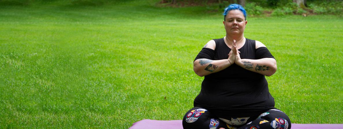 woman sitting on yoga mat