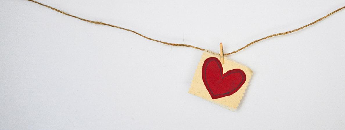 heart painted on paper hanging from string