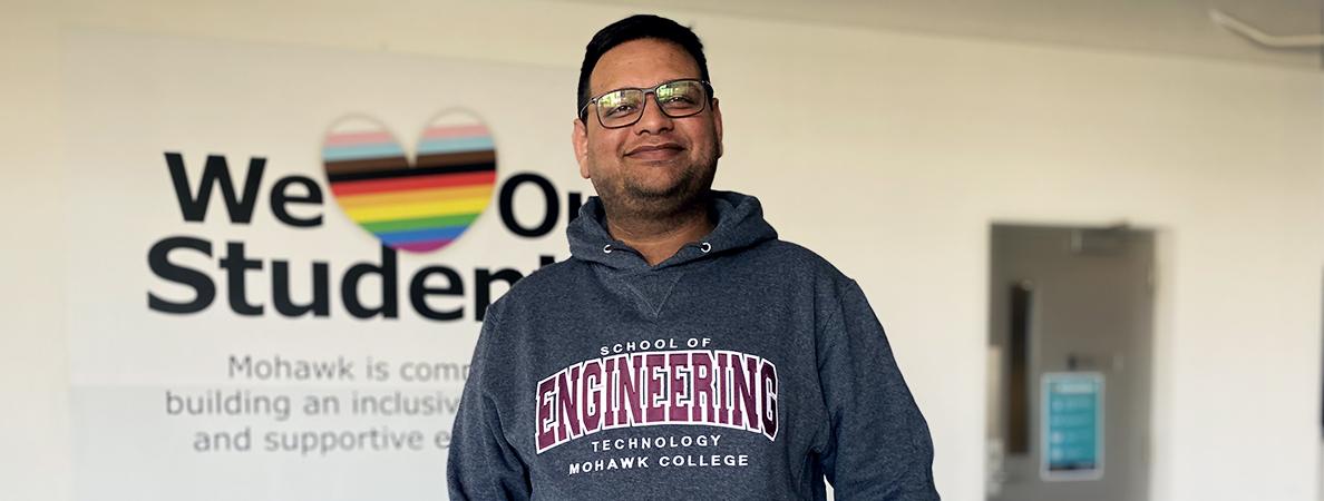 Hamza wearing a "School of Engineering Technology Mohawk College" sweater