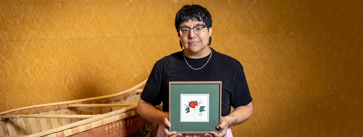 Lacey King-Smith holding a picture frame of the CIRKL logo.