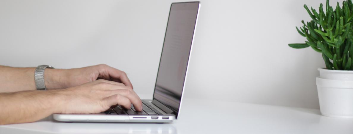hands using laptop