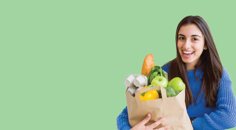 Student holding groceries