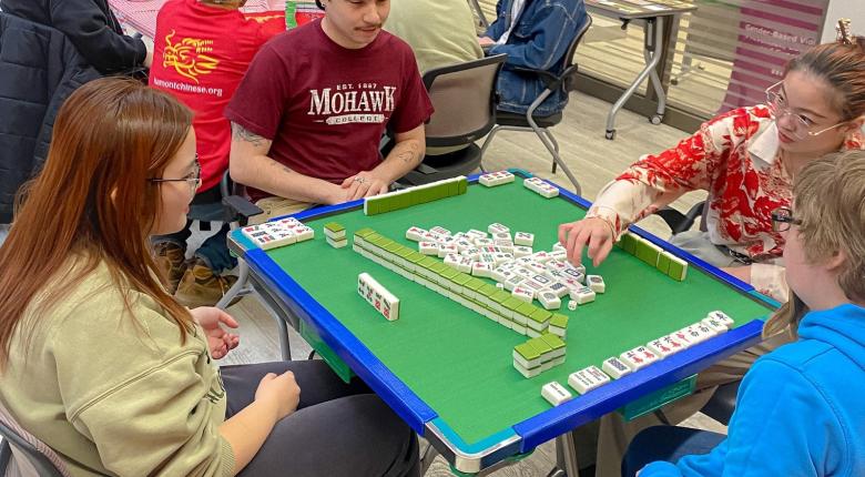 A group of students playing the Mahjong 