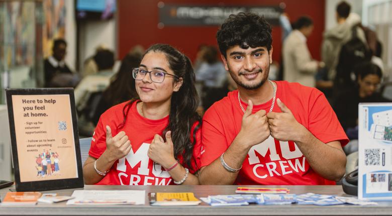 Two MoCrew students giving a thumbs up and smiling