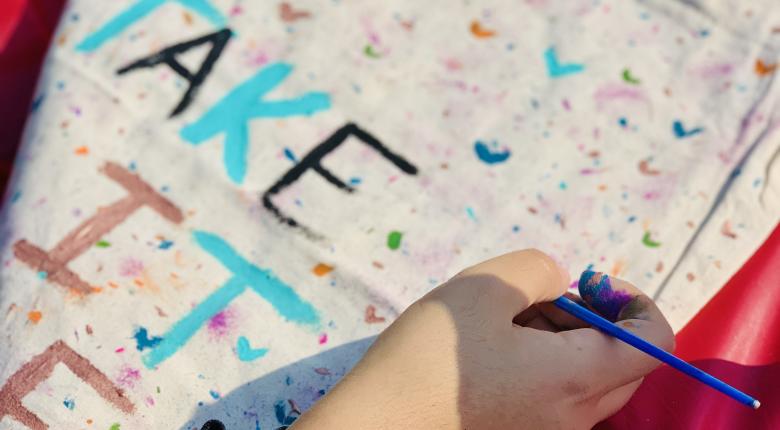 hand painting a tote bag