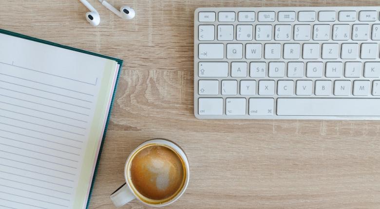 Desk with keyboard and coffee