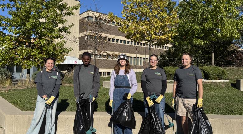 Group of students cleaning up litter on campus.
