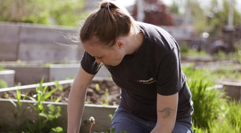 Summer student planting in the community garden. 