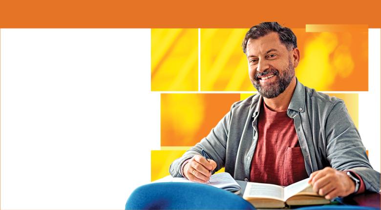 Mature student on orange background studying