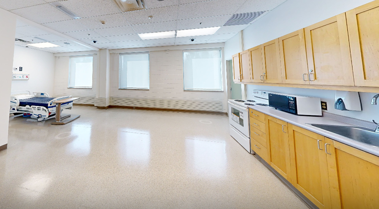Lab showing a bed and kitchen area at Mohawk College IAHS Campus