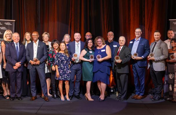 Alumni of Distinction group photo on stage.