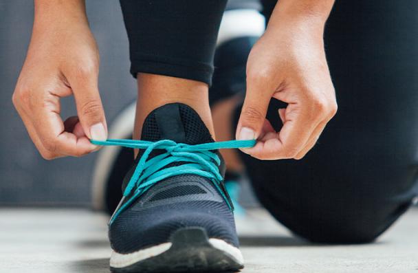 student athlete tied her shoe ready to run 