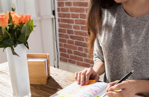 woman jot notes in shiny room