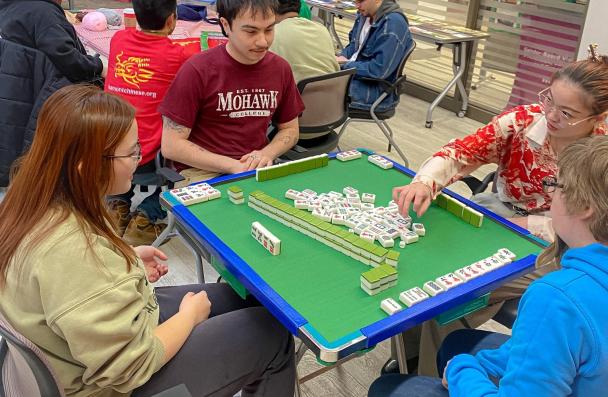 A group of students playing the Mahjong 